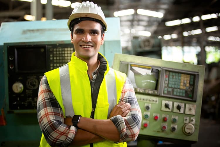 Engineer standing confidently in a factory environment