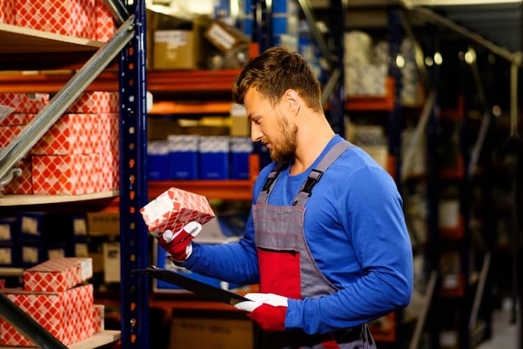 Worker in an industrial spare parts warehouse