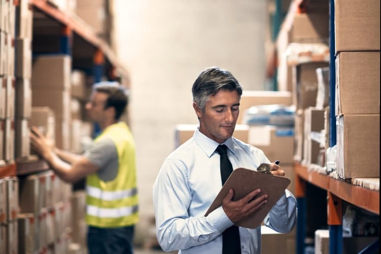 Shot of a mature man inspecting inventory in a distribution warehouse that will be sold