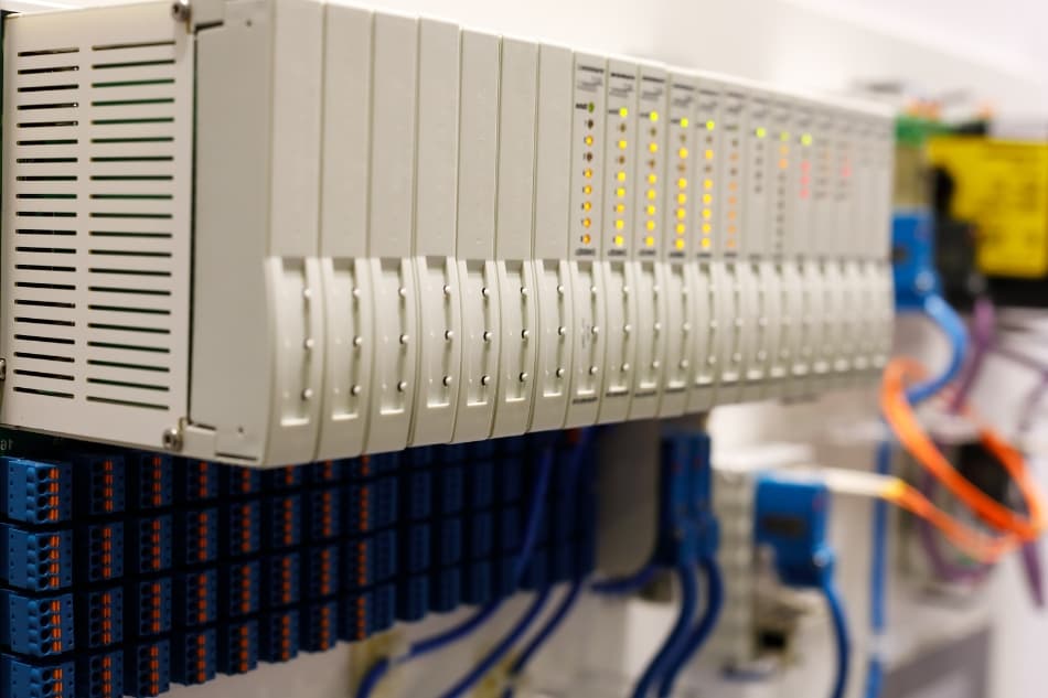 Programmable logic controller PLC modules installed in a rack. Selective focus
